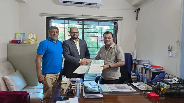 Abdul Kader Chowdhury with guests during a document signing