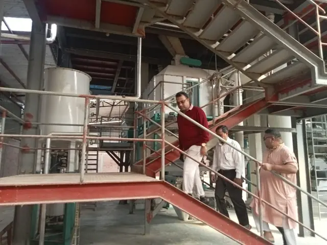 Visitors on the stairs inside a processing plant