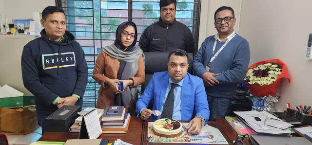 Abdul Kader Chowdhury with team members at the office