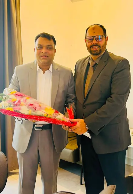 Abdul Kader Chowdhury receiving a welcome bouquet